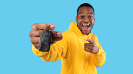 A person holding the keys to their new GMC Sierra 1500