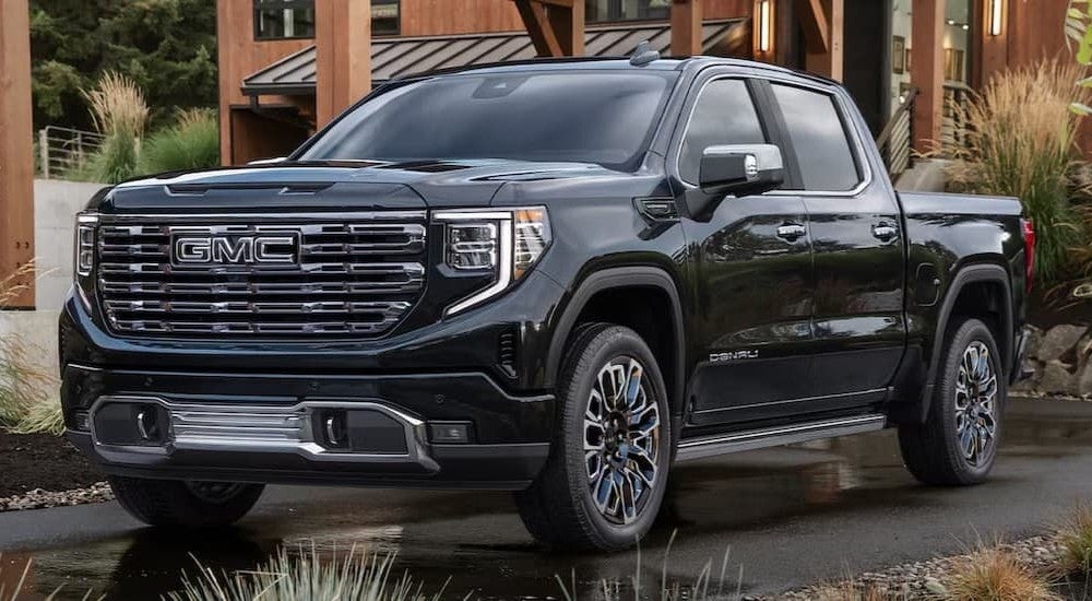 A black 2026 GMC Sierra 1500 parked near a house.