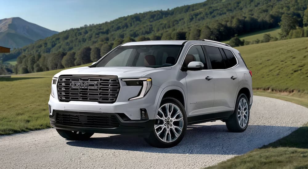 A white 2026 GMC Acadia Denali Ultimate parked in a driveway