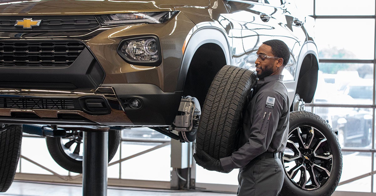 Chevrolet service technician rotating tires