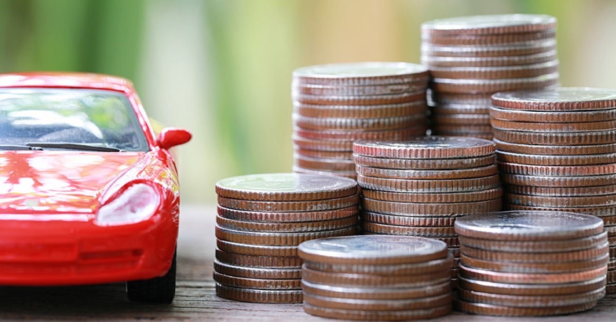 Car next to a stack of coins