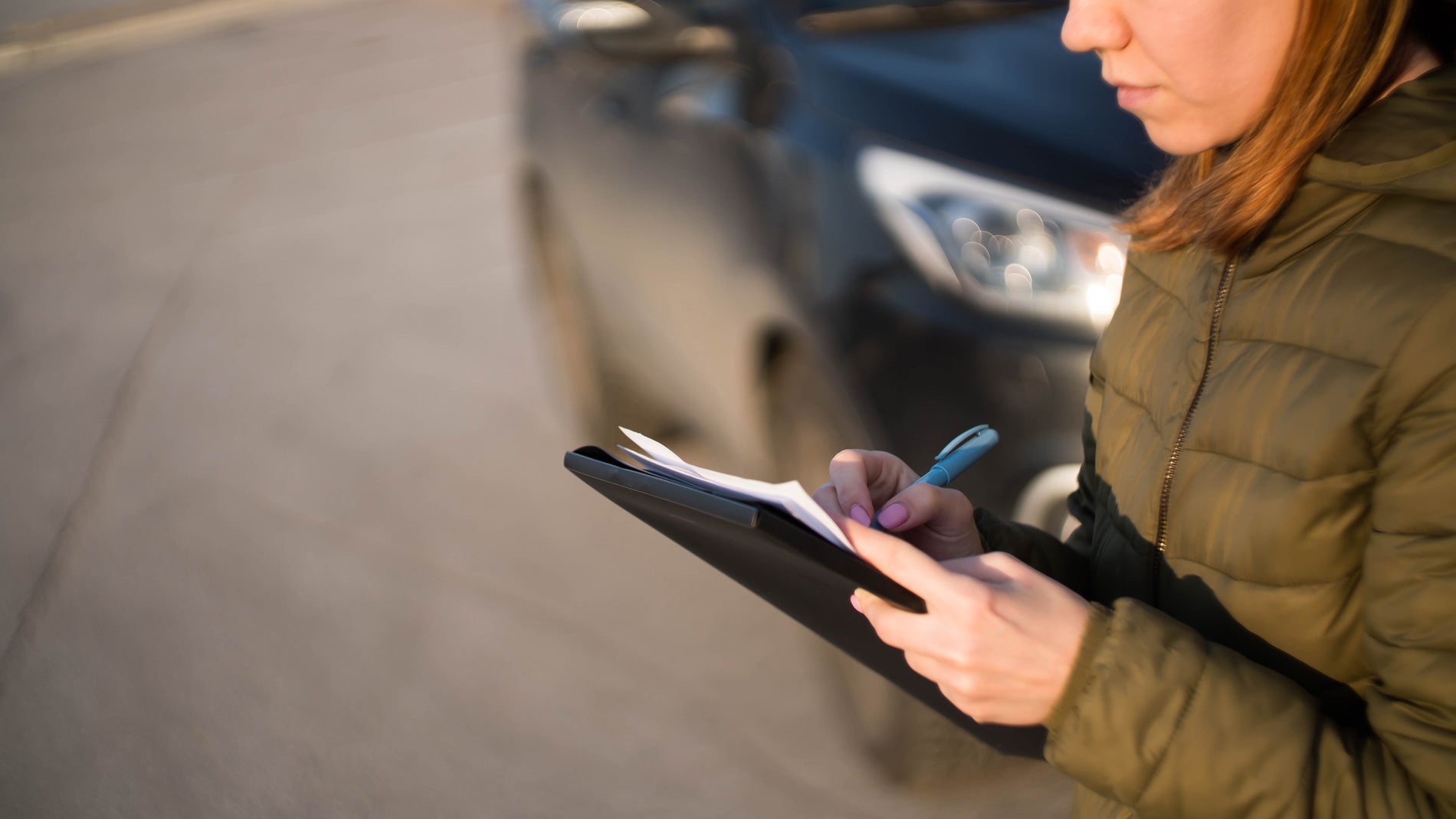 Woman filling out lease paperwork