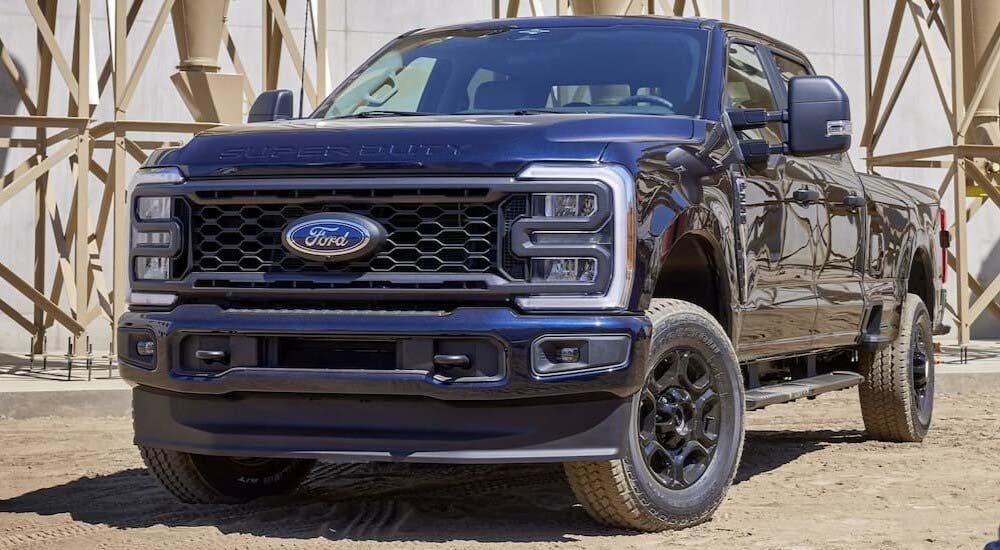 A black 2024 Ford F-250 Super Duty is shown parked off-road.