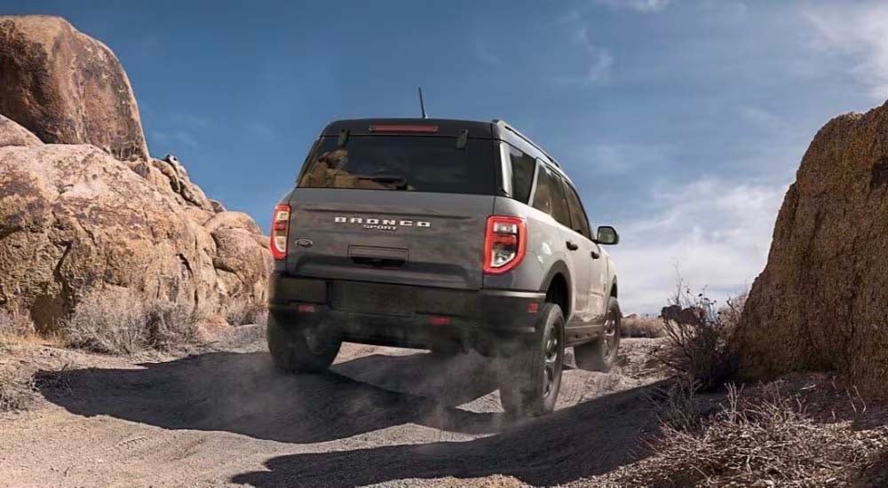 2024%20Ford%20Bronco%20Sport%20-%20Rear%202.jpg A gray 2024 Ford Bronco Sport is shown driving off-road.