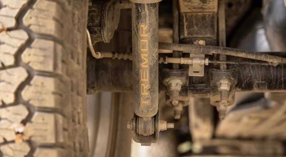 A close up shows the Tremor logo on the shock absorber of a 2021 Ford F-150 Tremor.