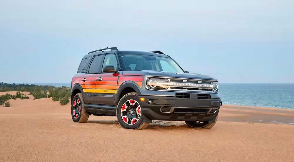 A silver 2024 Ford Bronco Sport Free Wheeling Edition is shown from the front at an angle on a beach…