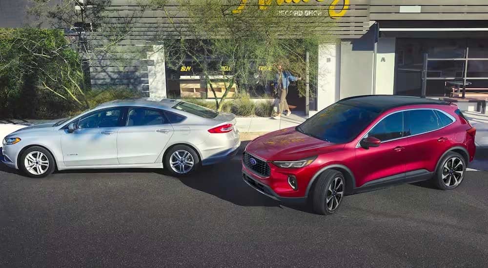 A red 2023 Ford Escape is shown parallel parking.