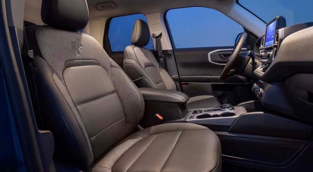 The black interior of a 2024 Ford Bronco Sport is shown from the passenger side.