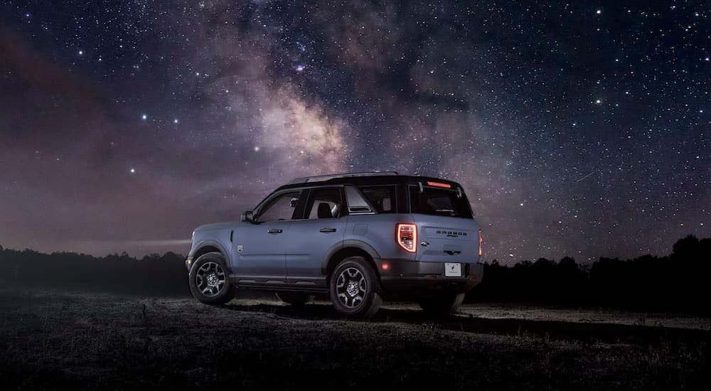 A blue 2024 Ford Bronco Sport is shown from the rear at an angle.