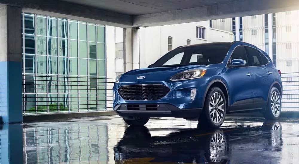 A blue 2020 Ford Escape is shown in a garage near an Evansville, IN used Ford dealer.