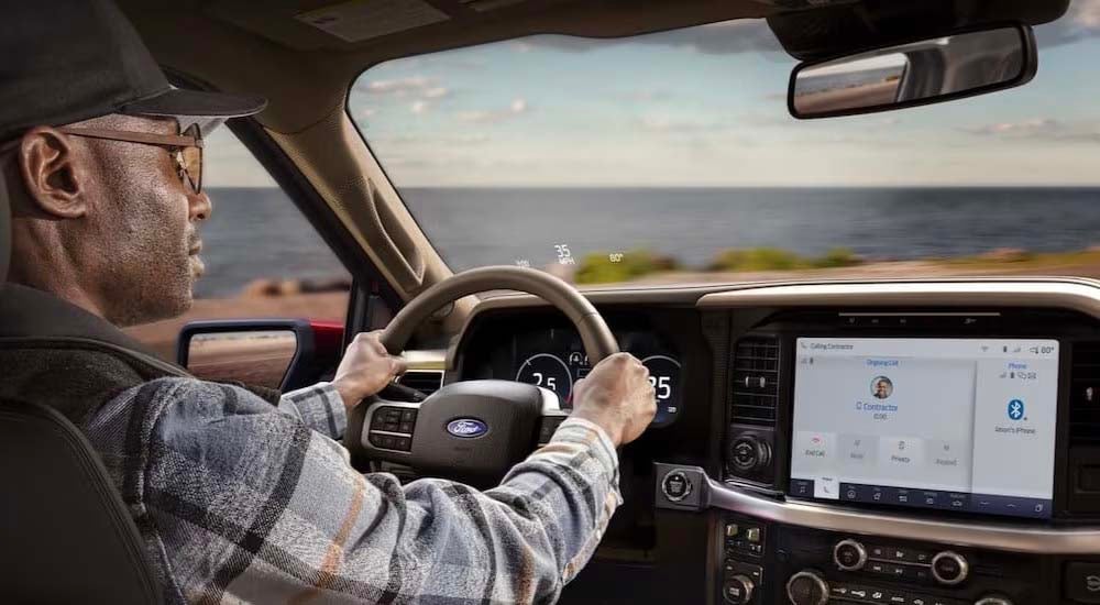 2024%20Ford%20F-150%20-%20Contractor.jpg A person is shown driving a 2024 Ford F-150 for sale.