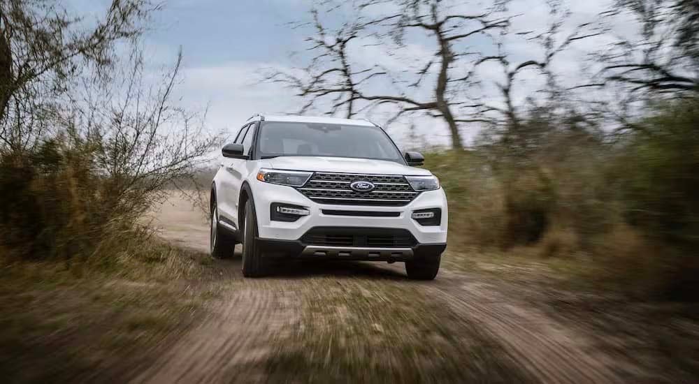 A white 2024 Ford Explorer King Ranch is shown from the front.