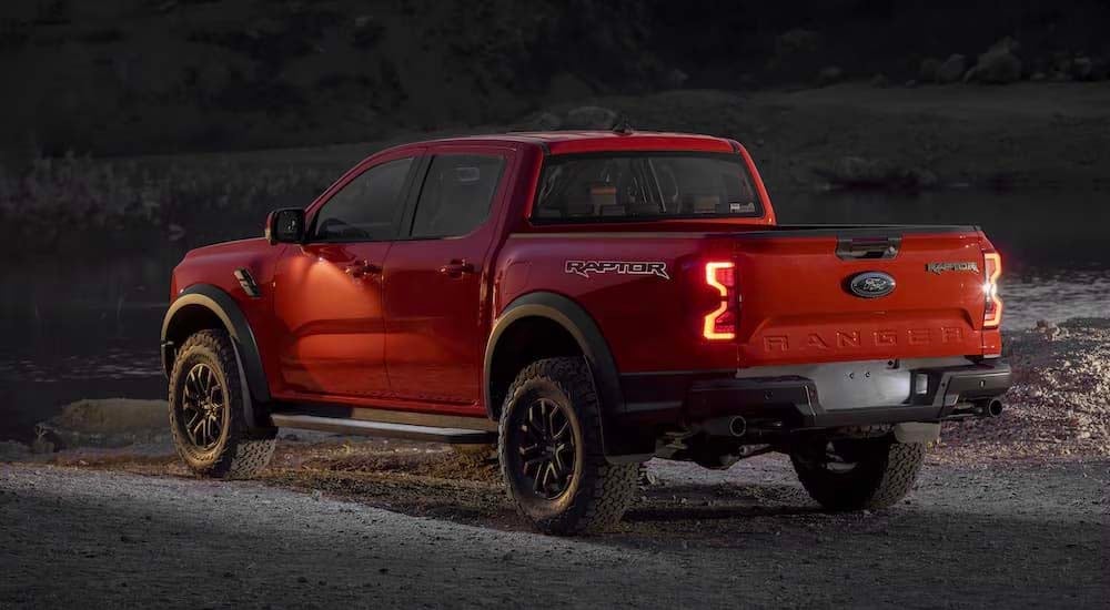 A orange 2024 Ford Ranger Raptor is shown from the rear at an angle after leaving a dealer