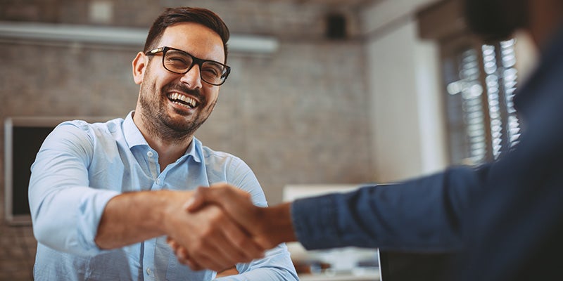customer shaking hands with a sales rep