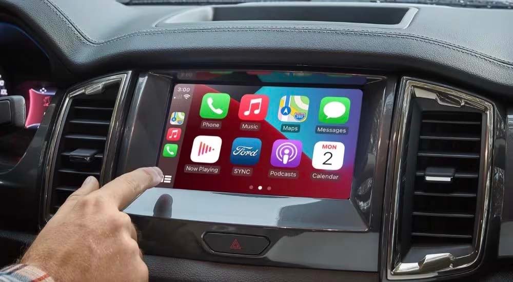 Someone is shown selecting an app on the touchscreen of a 2023 Ford Ranger.