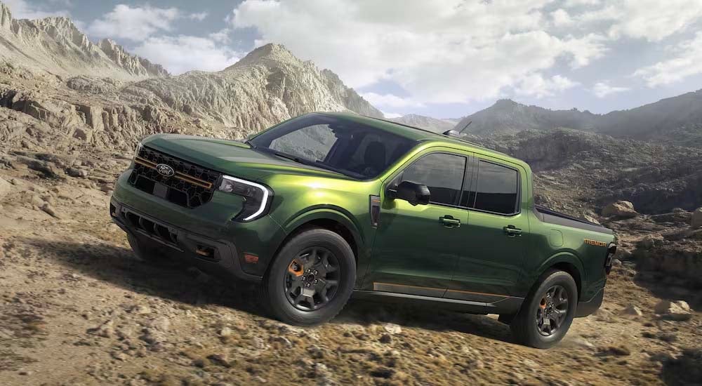 A green 2025 Ford Maverick Tremor off-roading up a rocky hill.