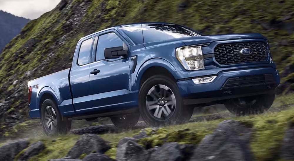 A blue 2022 Ford F-150 STX is shown from the side after leaving a Ford F-150 dealer near Evansville