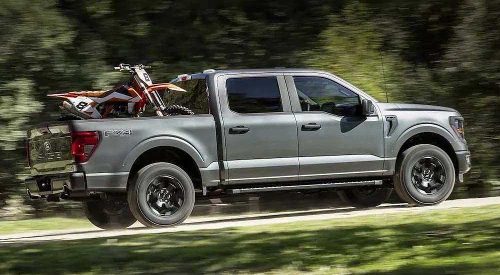 2024%20Ford%20F-150%20-%20Dirtbikes.jpg A gray 2024 Ford F-150 is shown driving off-road.