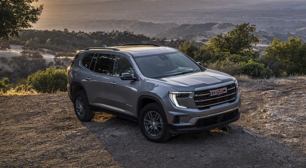 A grey 2025 GMC Acadia Elevation parked off-road