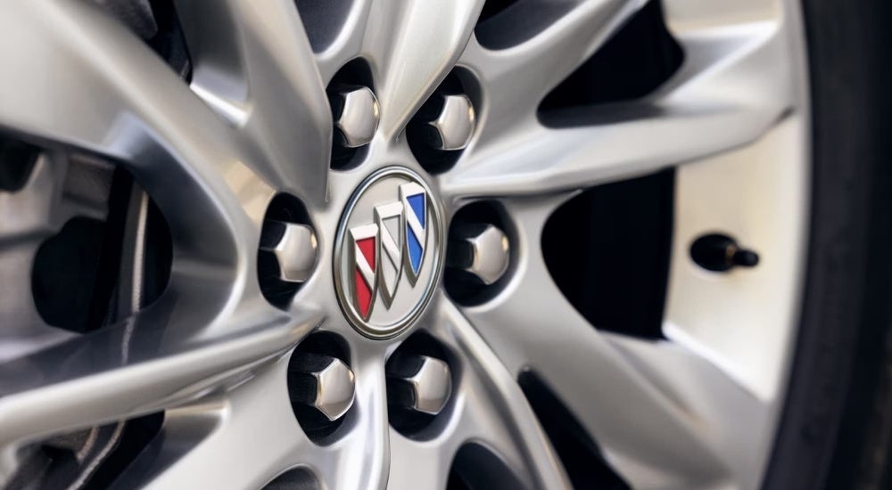 A close up shows a silver wheel on a 2024 Buick Enclave.