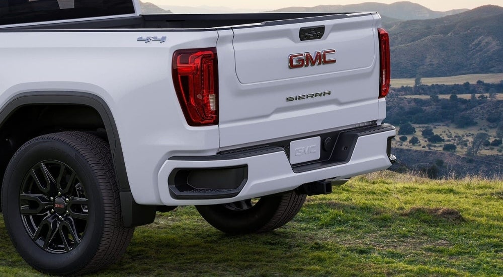 A close-up shows the rear of a white 2024 GMC Sierra 1500.