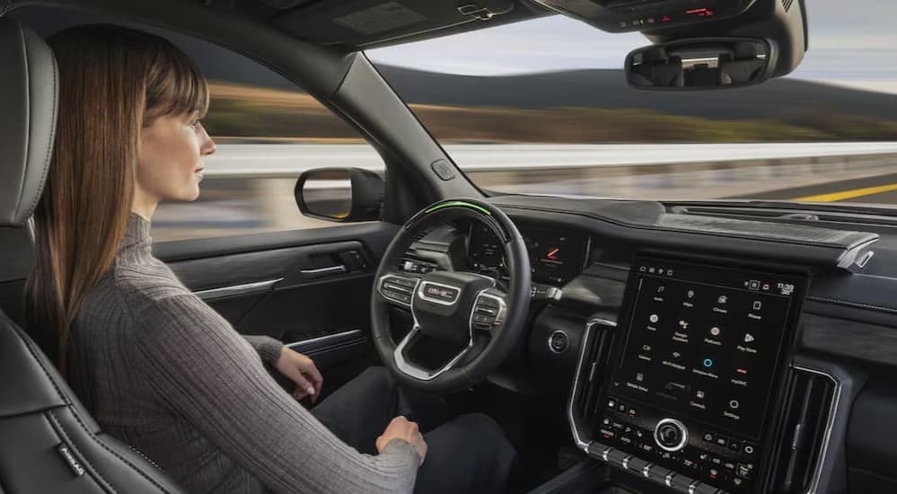 A person driving a 2025 GMC Acadia.