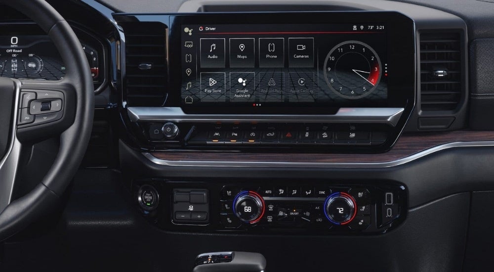 A close-up shows the infotainment screen in a 2024 GMC Sierra 1500.