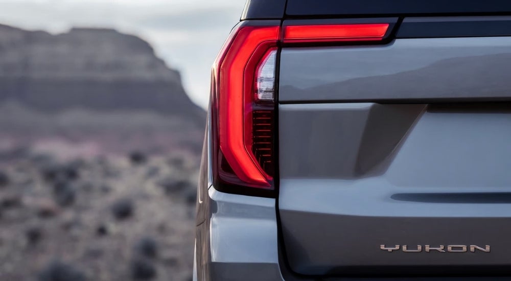 A close-up shows driver side taillight on a grey 2025 GMC Yukon XL.