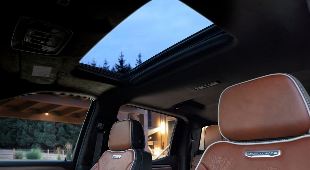 A close-up shows brown leather headrests in a 2024 GMC Sierra 1500 Denali Ultimate.