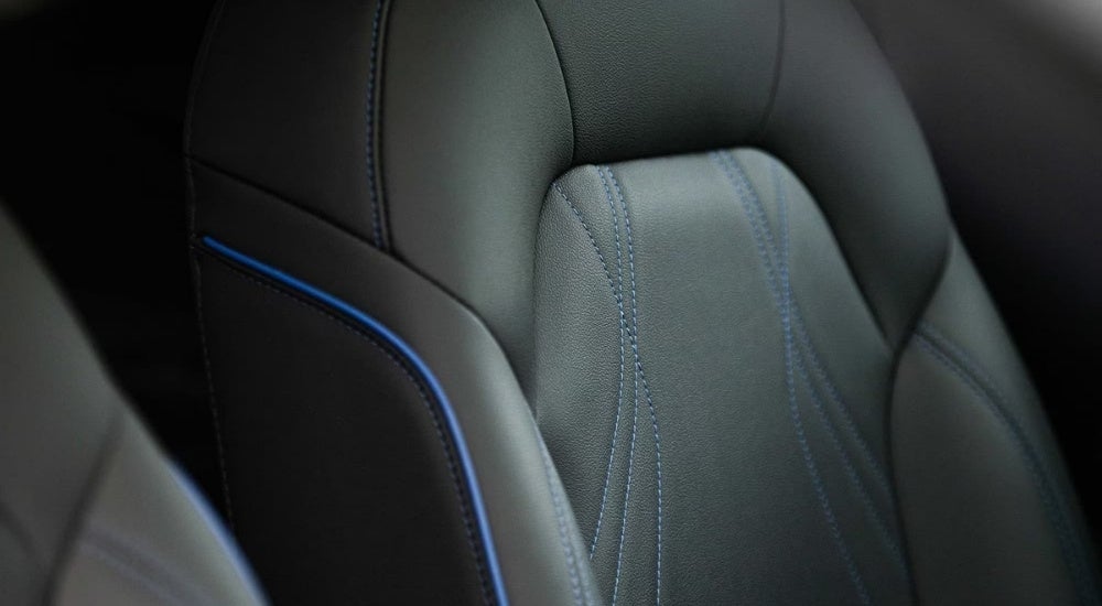 A close-up shows a black leather seat in a 2025 Buick Envista.