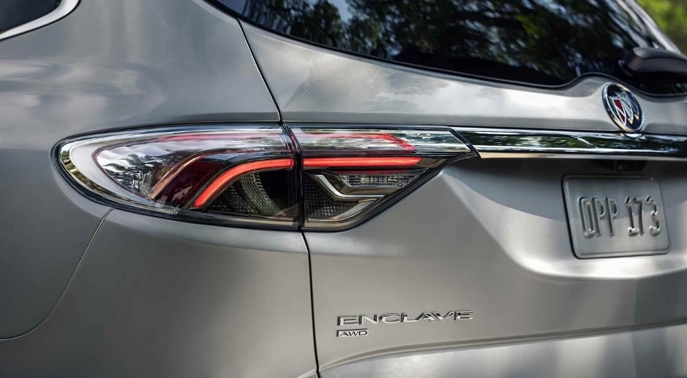 A close-up show the driver side taillight on a silver 2024 Buick Enclave Avenir.