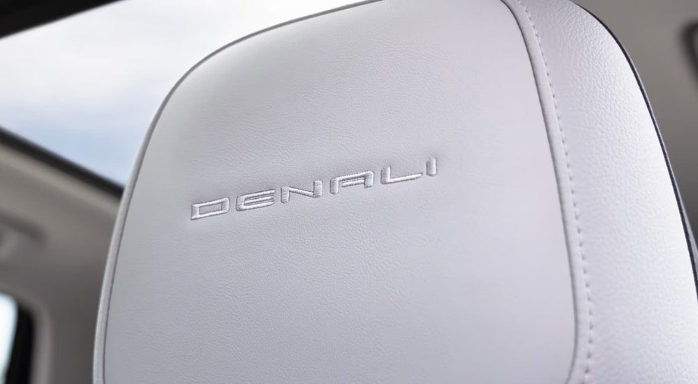 A close-up shows a white leather headrest in a 2025 GMC Terrain Denali.