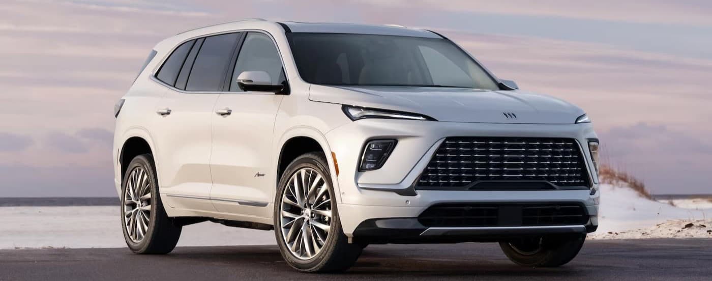 A white 2026 Buick Enclave parked near a beach.