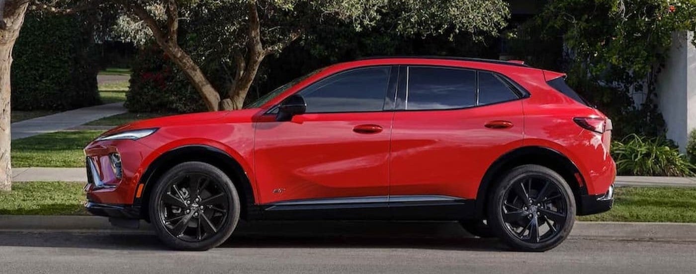 A red 2026 Buick Envision parked near a curb.