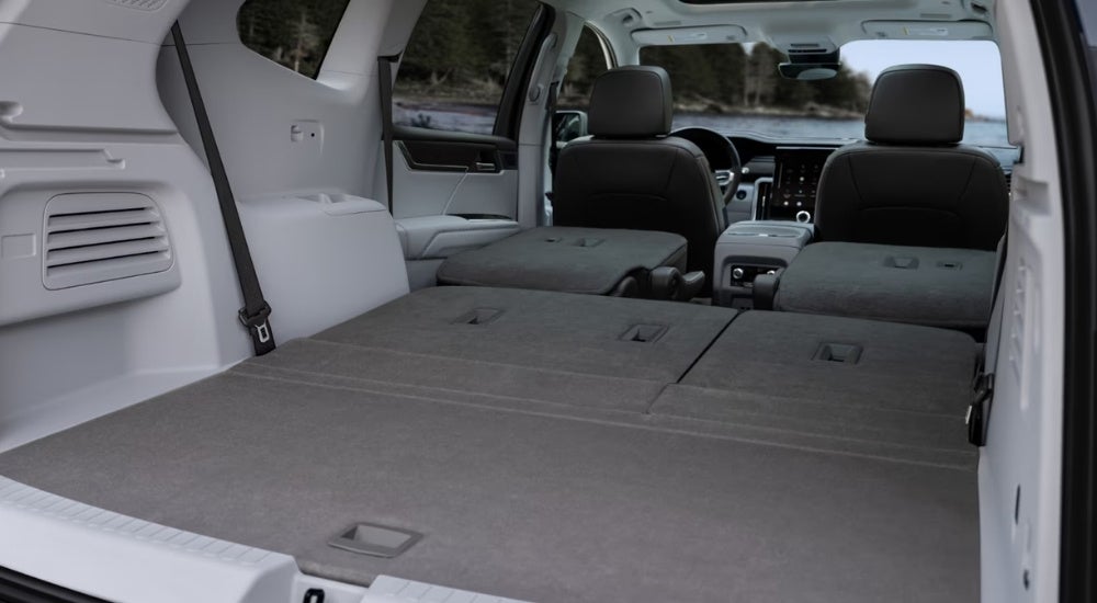 The rear cargo area of a 2024 GMC Acadia is shown.