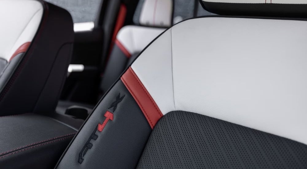 A close-up shows the AT4X badge on a leather seat in a 2023 GMC Canyon AT4X.