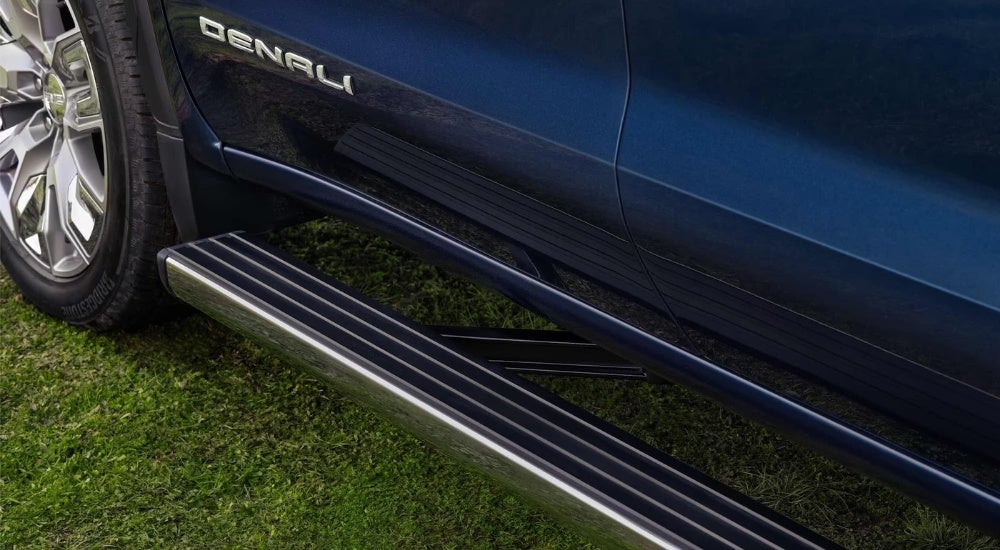 A close up shows the Denali badge on a blue 2023 GMC Sierra 1500 Denali.