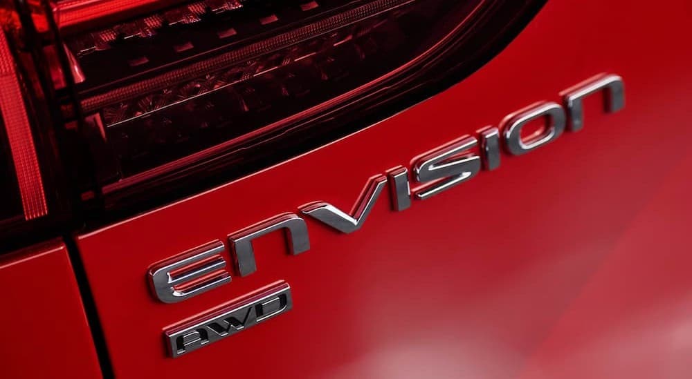 Envision logo on a red 2026 Buick Envision.