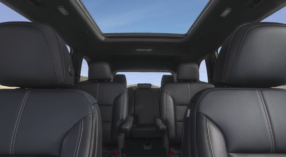 Black leather seating is shown in a 2024 GMC Acadia Elevation.