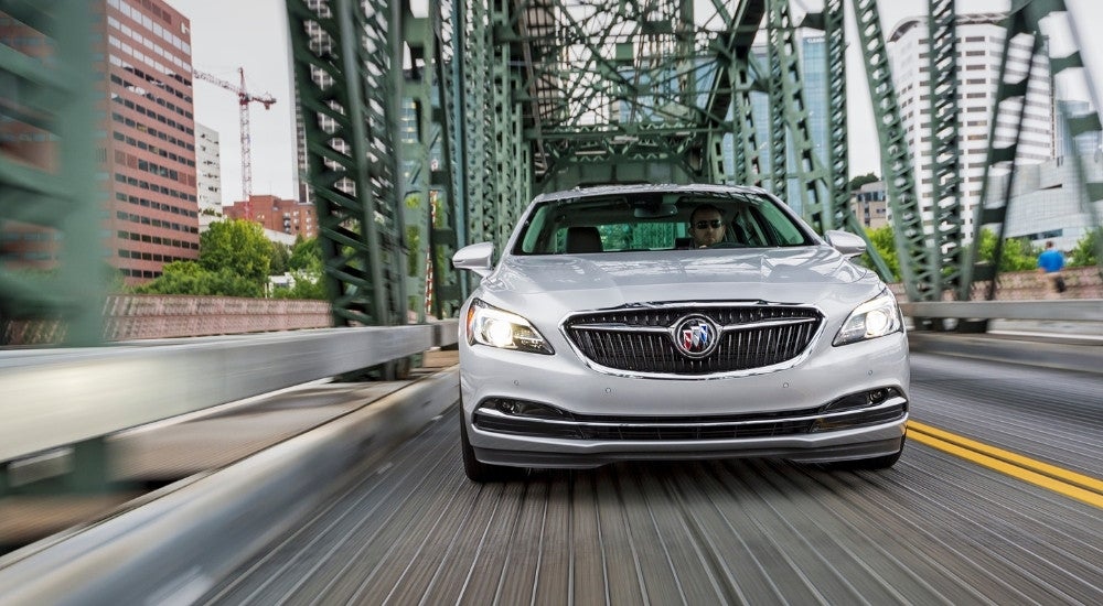 A silver 2019 Buick LaCrosse is shown driving over a bridge.