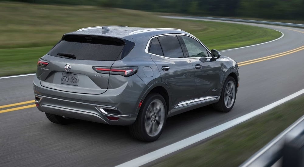 A grey 2023 Buick Envision Avenir is shown rounding a corner.