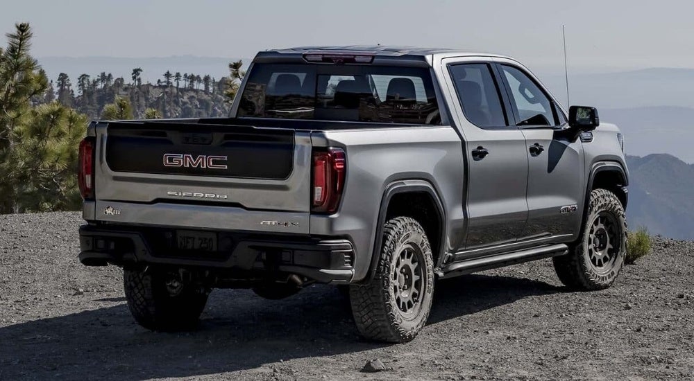 A grey 2024 GMC Sierra 1500 AT4X AEV is shown at an overlook.