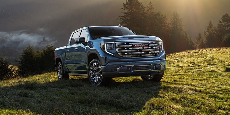 GMC pickup truck on hillside
