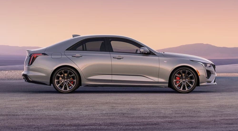 A silver 2026 Cadillac CT4 parked off-road.