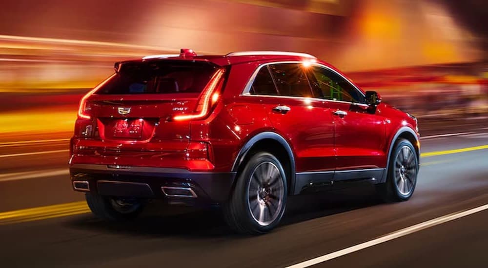 A red 2024 Cadillac XT4 driving in a tunnel.