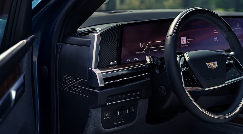 Close-up on the steering wheel in the interior of a 2027 Cadillac Escalade.