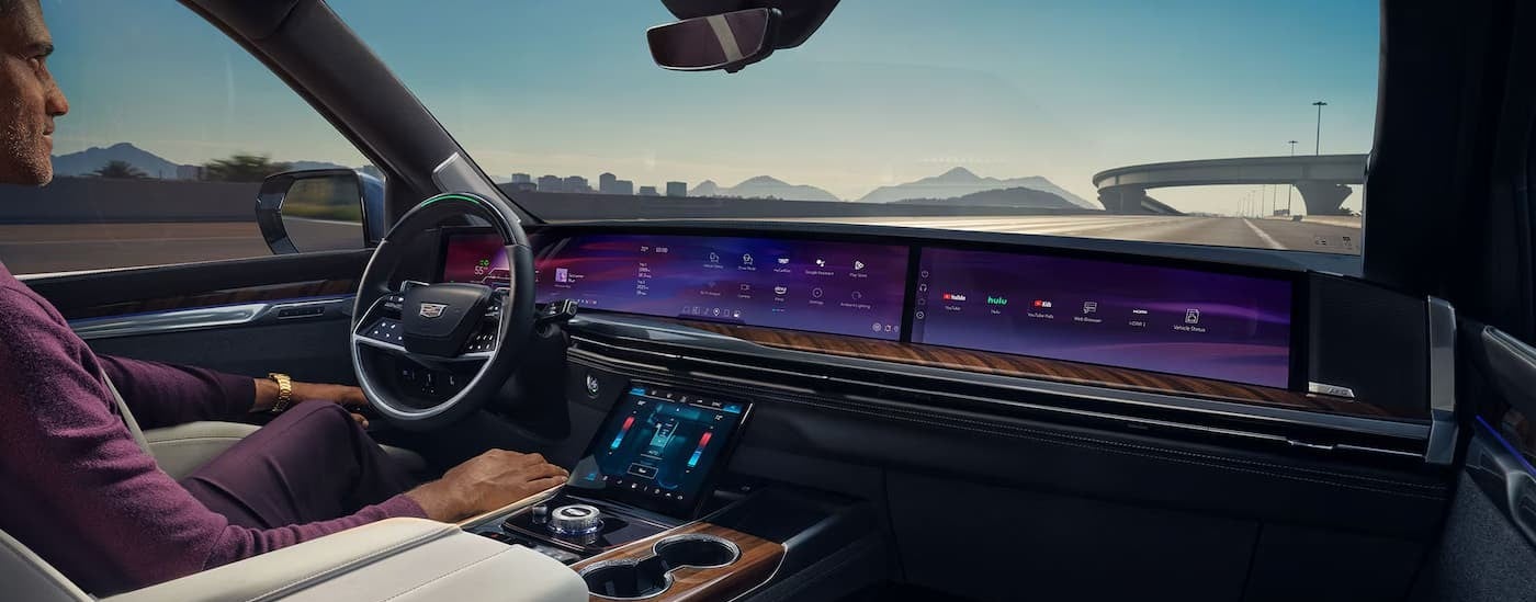 A person driving in a 2027 Cadillac Escalade.