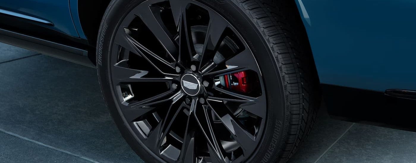 A wheel on a blue 2027 Cadillac Escalade.