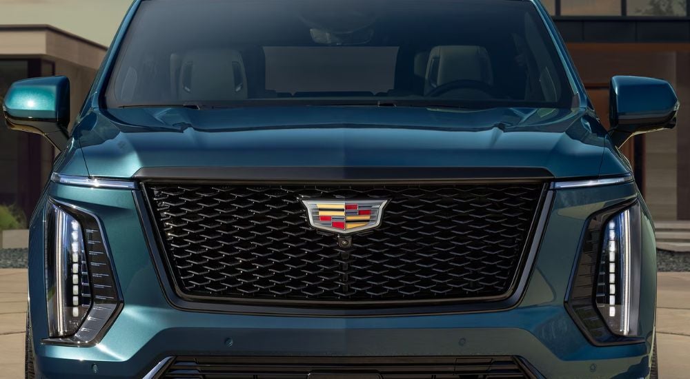 Front grille of a blue 2026 Cadillac Escalade.