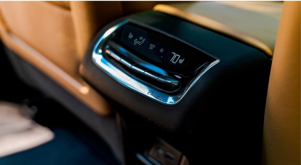 A close-up shows HVAC controls in a 2024 Cadillac XT6.